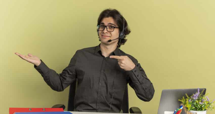 Man wearing a headset at a desk.